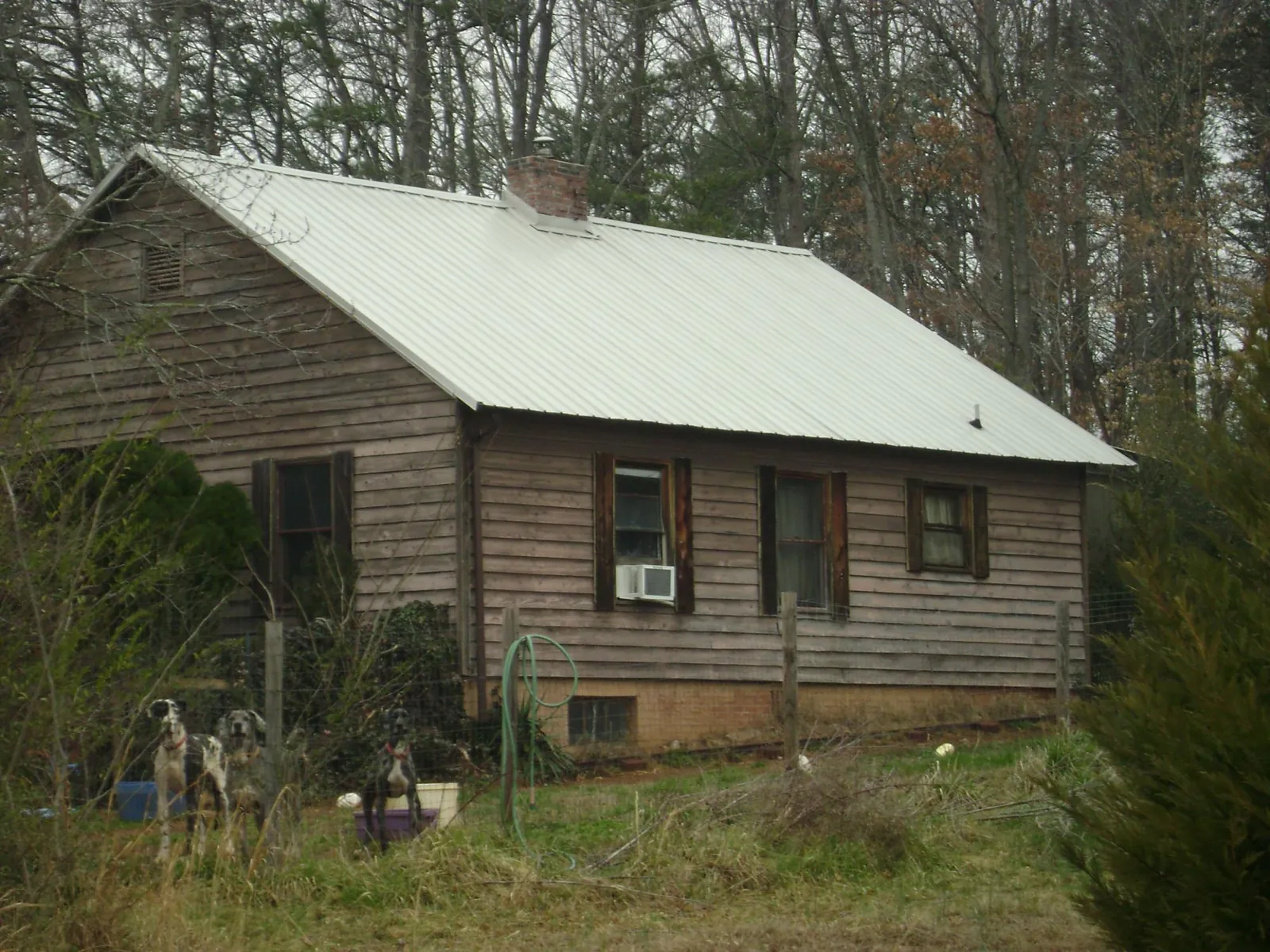 White metal roof on an old wood sided farmhouse, from a Metal Roof Installation job in New York Mills